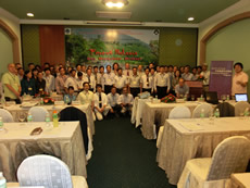 Photo of participants in front of the billboard of the symposium.